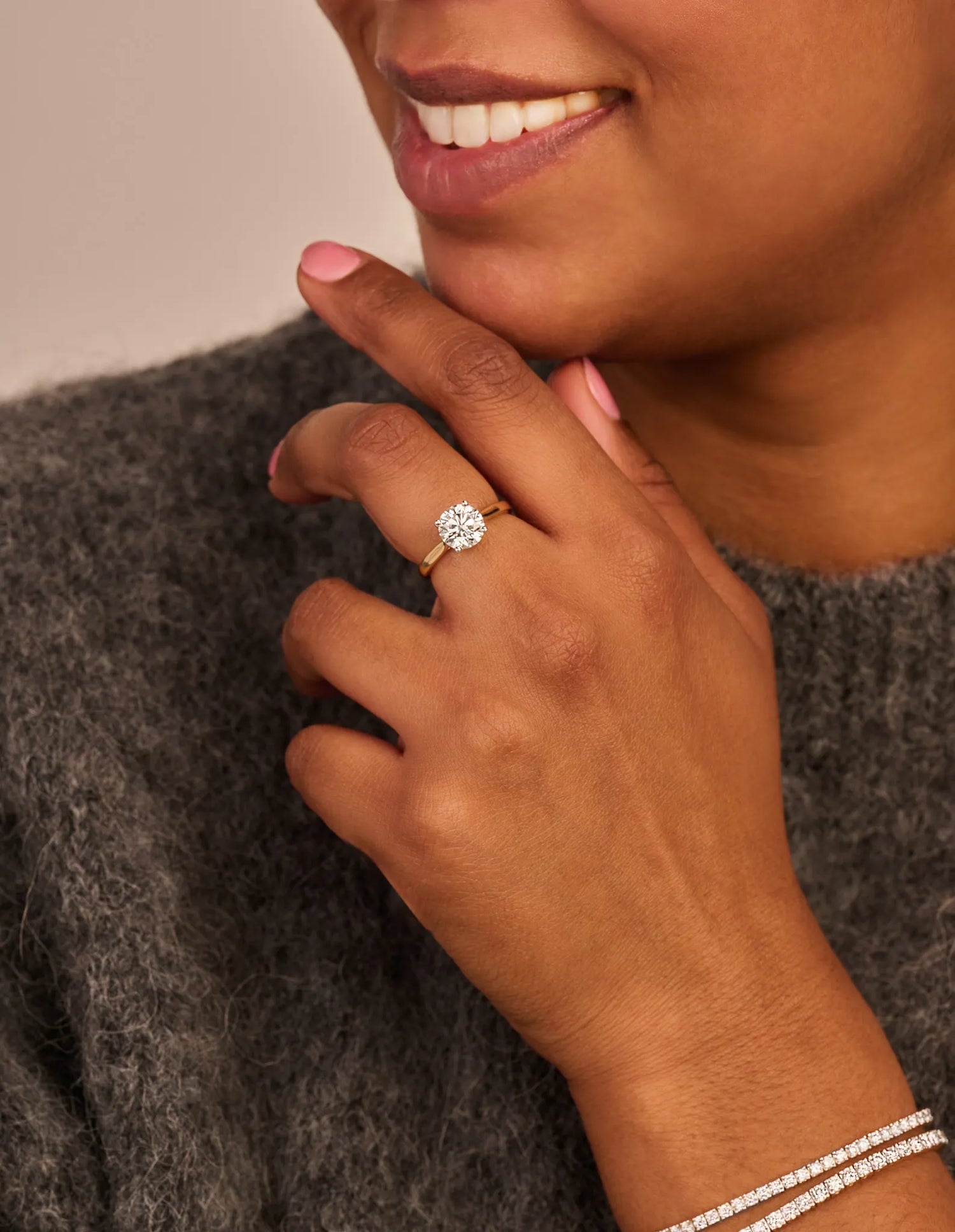 Louen Diamonds solitaire ring van 14k geelgoud met een 2.0ct diamant op model in volle trui close up